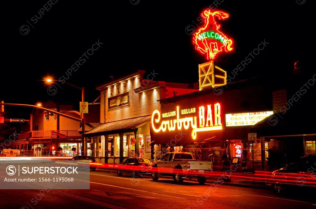 Cache Street lights and the Cowboy Bar at night downtown in the city of Jackson Wyoming