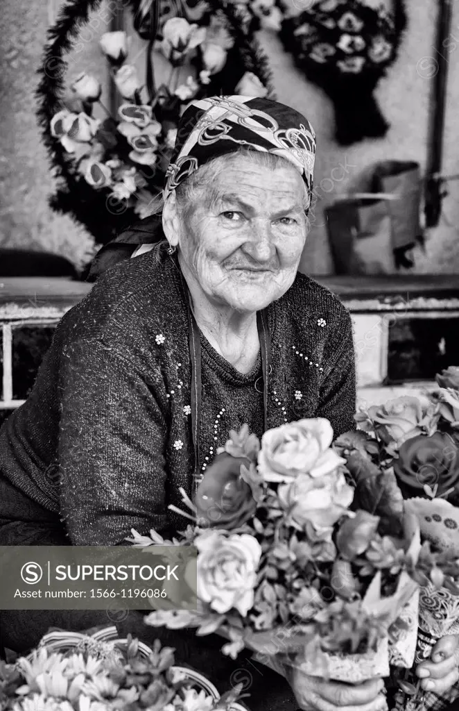 Old lady babushkas selling flowers at market in old town center city of Lviv Ukraine