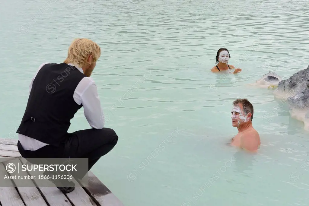 Iceland, Rekjavik region, Blue Lagoon Geothermal spa, staff member and bathers with silica mud masks
