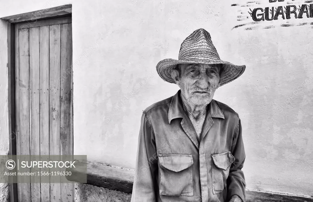 Portrait of poor man with straw hat in small town of Australia Cuba