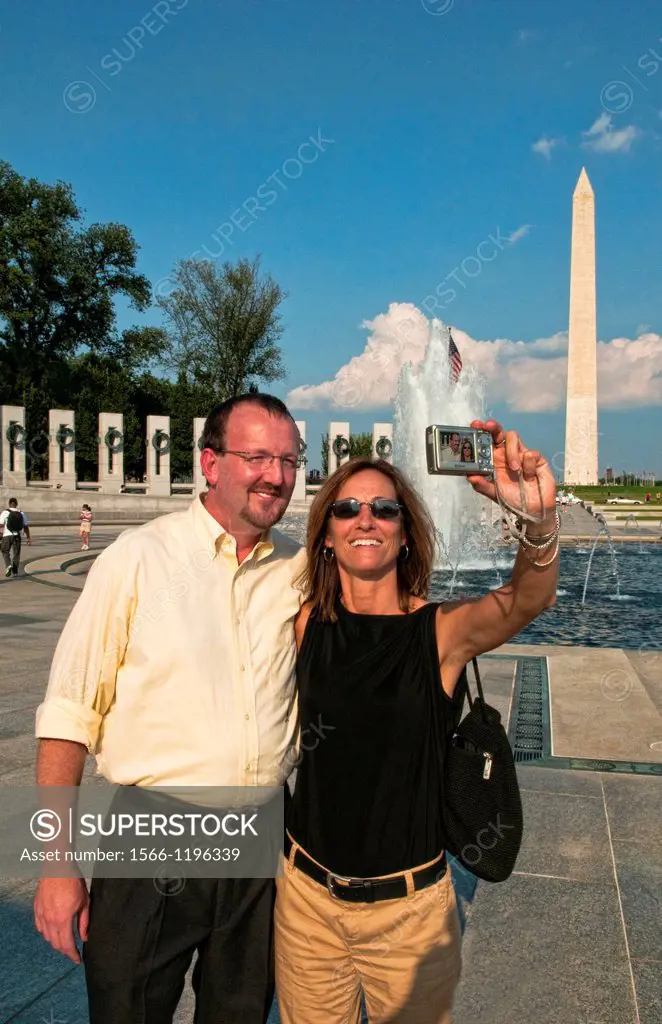 Tourists taking self photo at New National World War II Memorial on the Mall in Washington DCin the USA honoring the heros of WWII in Europe war