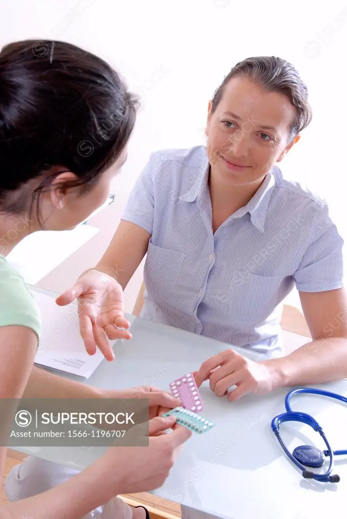 Family planning  General practice doctor discussing oral contraception with a young woman