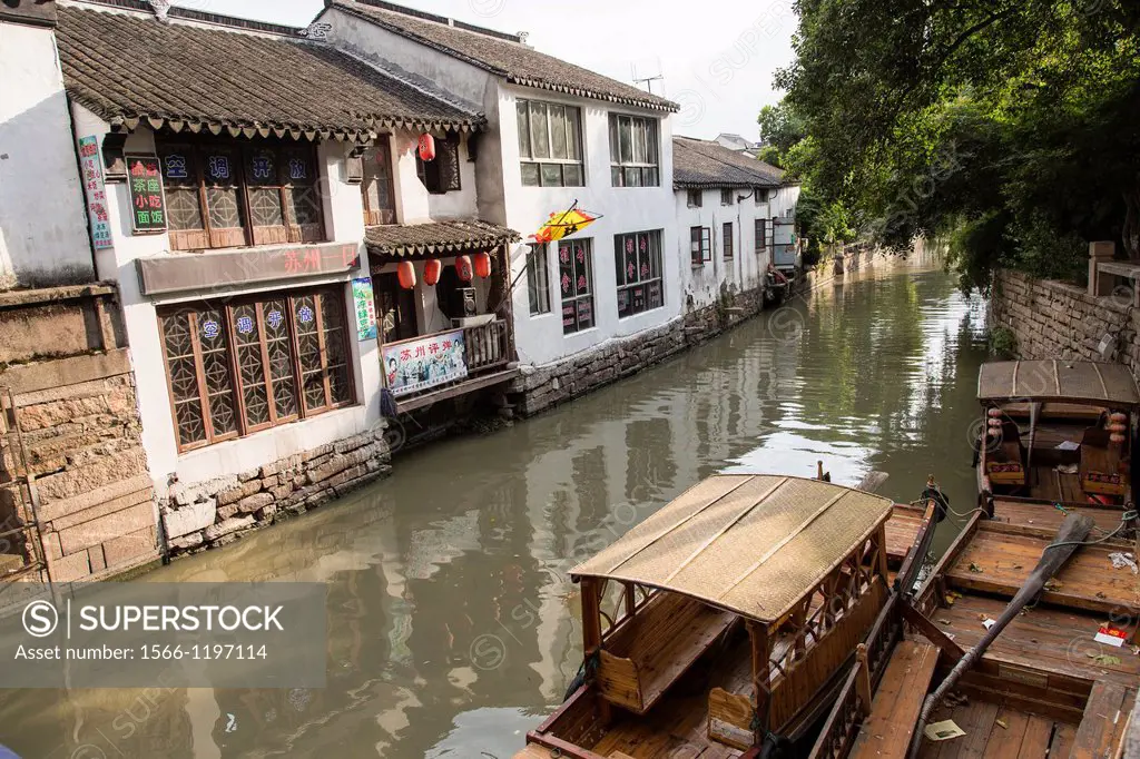 Boats and gondolas along a canal at Pingjiang Road in Suzhou, China