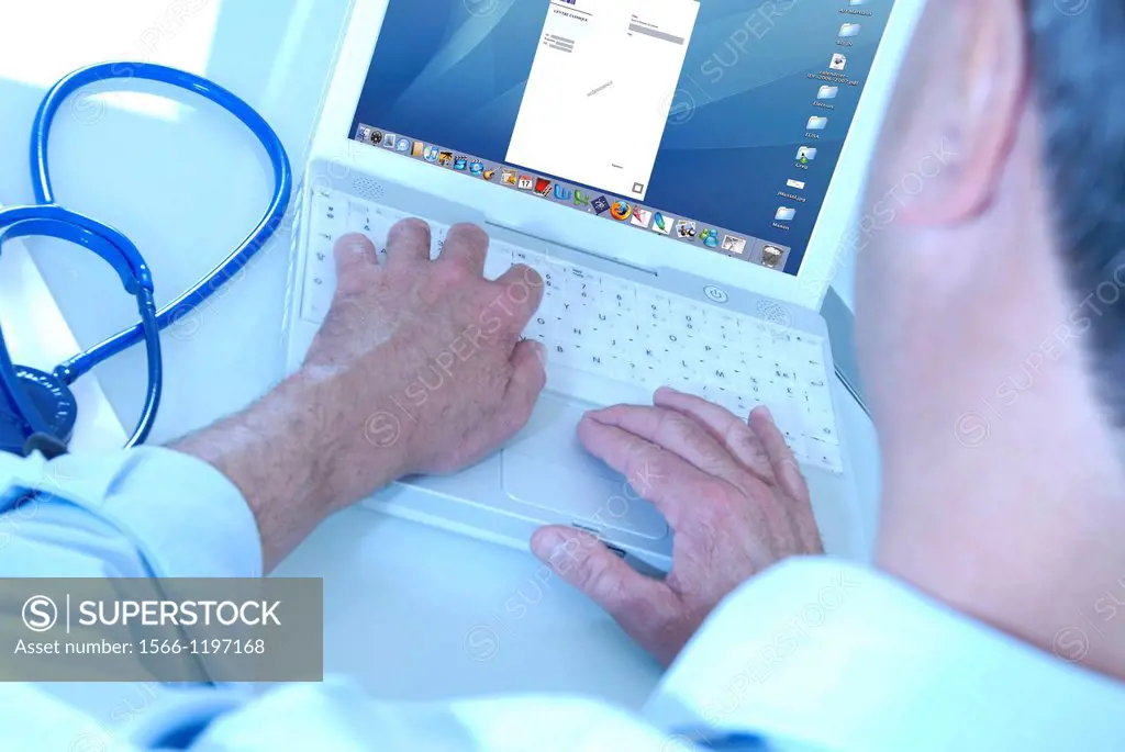 Doctor typing a prescription on a computer in his office