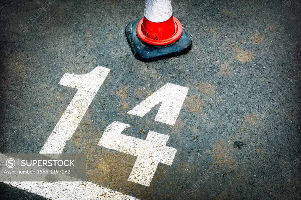 urban simbolism, asphalt road marking in a parking, number fourteenth