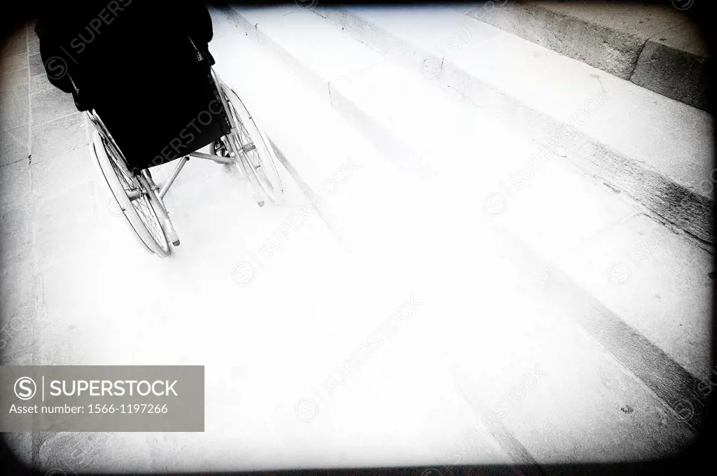 invalid on the street in a wheelchair traveling
