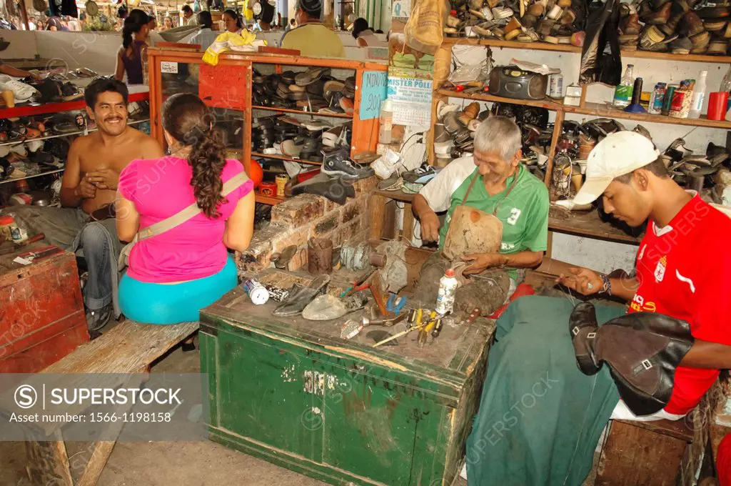 Shoe makers repairing shoes, Colombia, South America