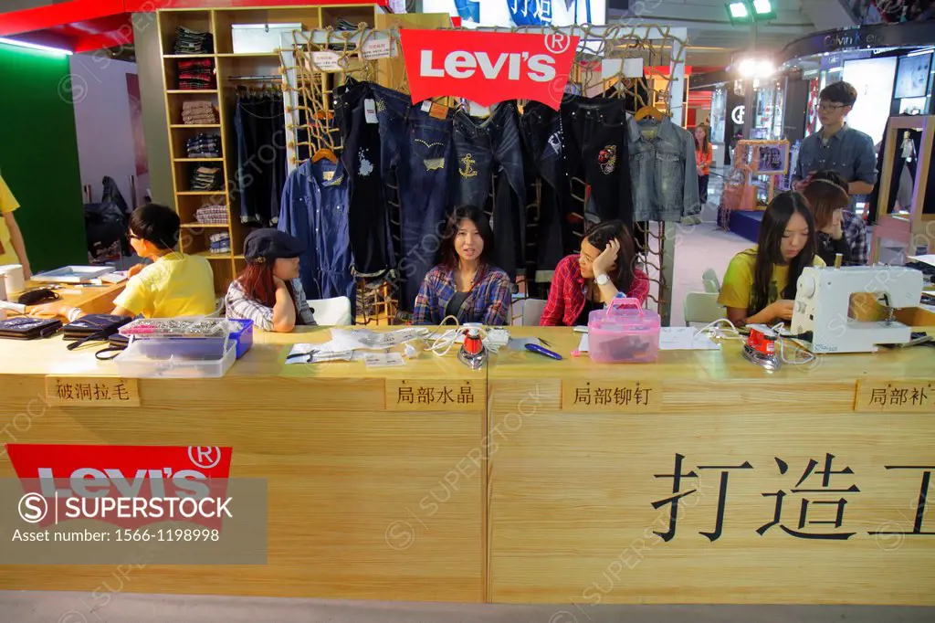 China, Shanghai, Huangpu District, Xizang Road, People´s Square, Raffles City, shopping, Levi´s, clothing, counter, Asian, woman,