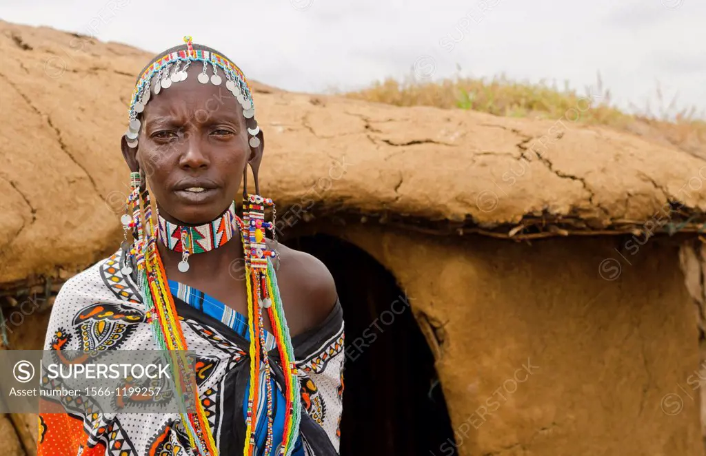 Amboseli National Park Kenya Africa safari Masai woman welcome to village Amboseli Maasai, hut, mud, home, beads, red, color, 1