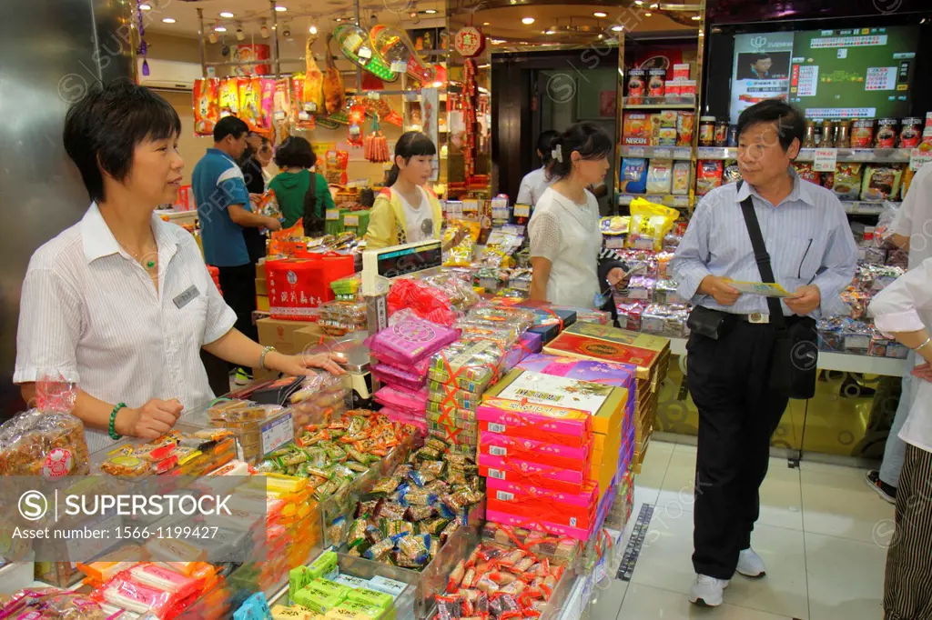 China, Shanghai, Huangpu District, East Nanjing Road, business, store, candy, sweets, treats, Asian, woman, clerk, job, employee, Chinese Mandarin sym...