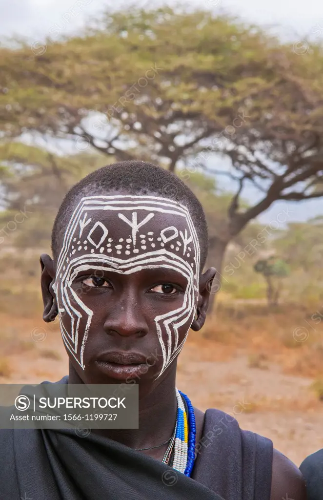 Tanzania Serengeti Africa Masai Maasai boys in black from circumcision ceremony with face paint and black clothes 7