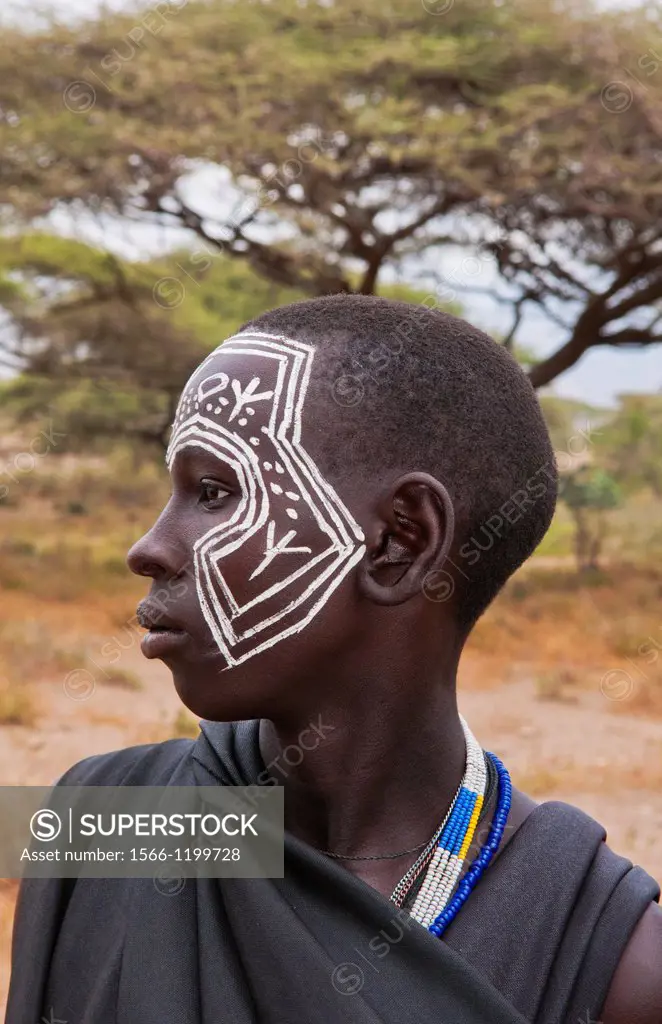 Tanzania Serengeti Africa Masai Maasai boys in black from circumcision ceremony with face paint and black clothes 7