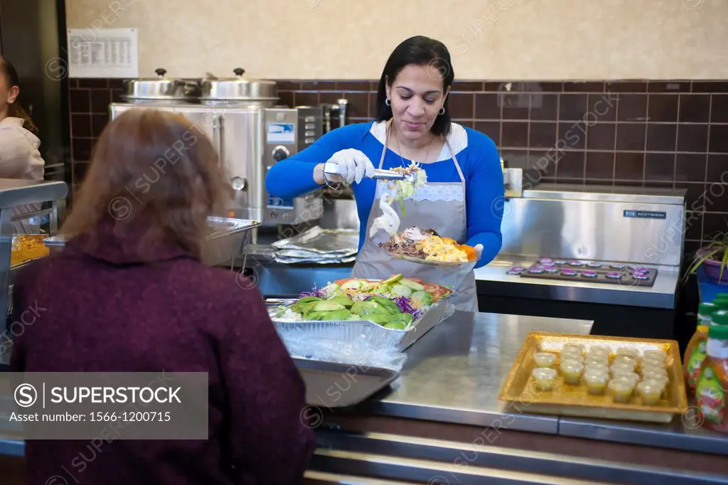 Volunteers from the United Palace Cathedral in the primarily Dominican Washington Heights in New York serve Thanksgiving Dinner to neighborhood reside...