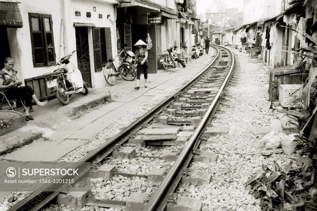 Daily life by the train tracks in Hanoi in Vietnam in Southeast Asia Far East