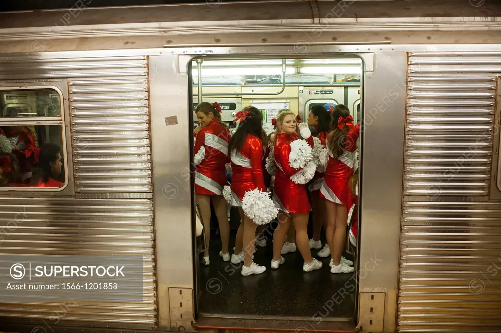 Members of the Varsity Spirit cheerleading team, travel back to their buses via the subway after leading the 86th Annual Macy´s Thanksgiving Day parad...