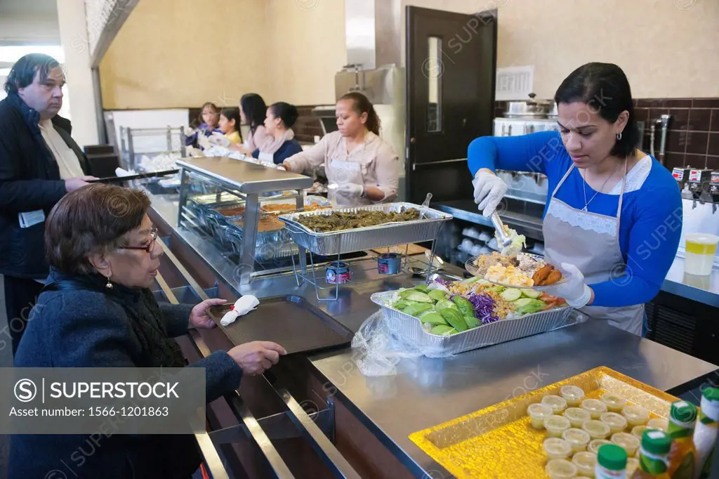Volunteers from the United Palace Cathedral in the primarily Dominican Washington Heights in New York serve Thanksgiving Dinner to neighborhood reside...
