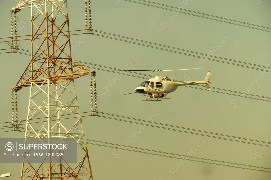 Repairing the High voltage towers with helicopter along the Taiwan highway.