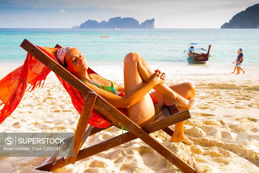 Young woman relaxing on a deckchair  Long beach  Phi Phi Don island  Krabi province, Andaman Sea, Thailand