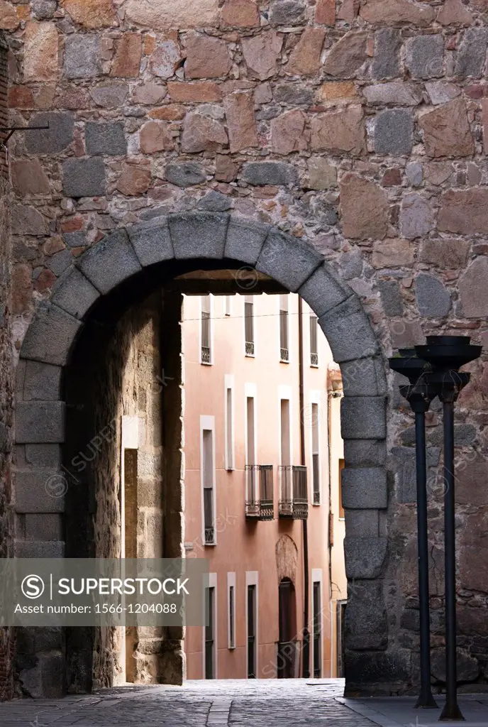 View of stone arch from Plaza de la Catedral, Ávila, Spain.
