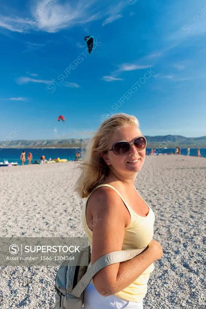 Tourist on Zlatni Rat beach in Bol on Brac island, Croatia