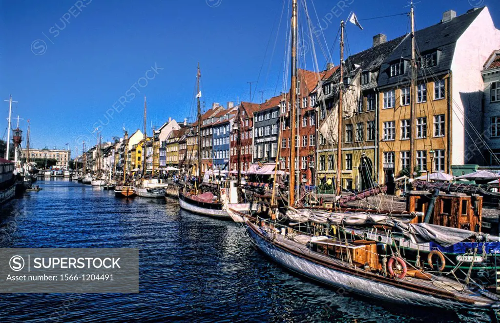 Life in Denmark with the famous Nyhavn Harbour with beautiful cafes and water in Copenhagen Denmark