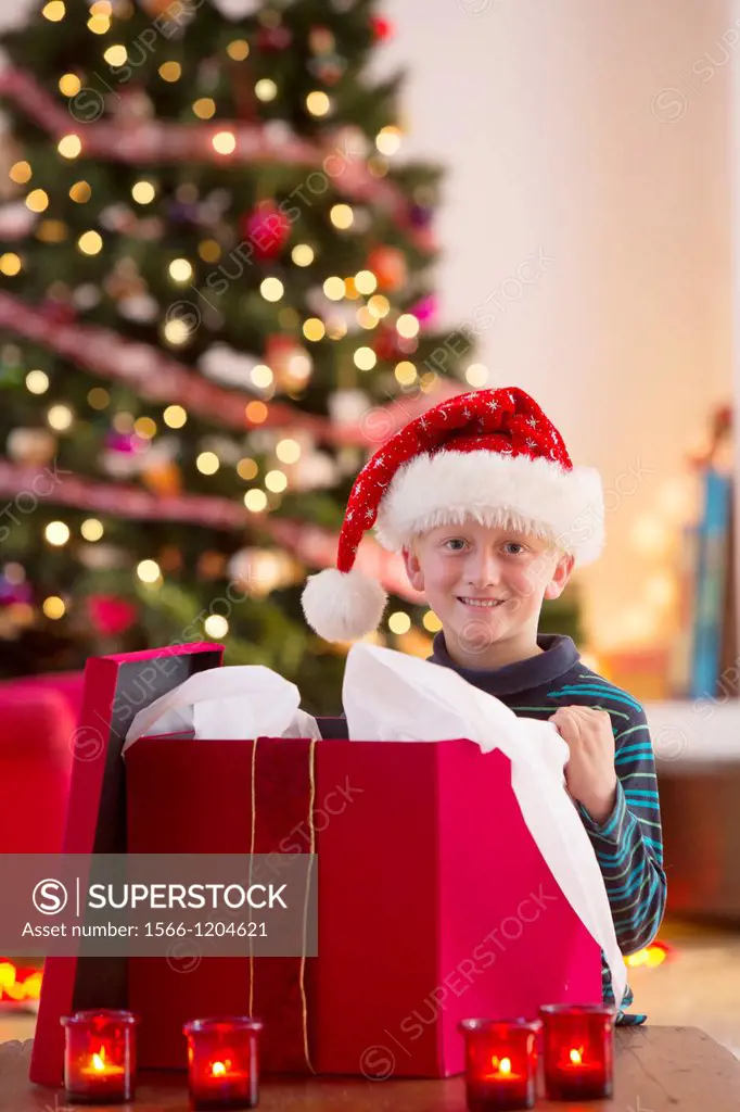 Young boy opening a Christmas present on Christmas day