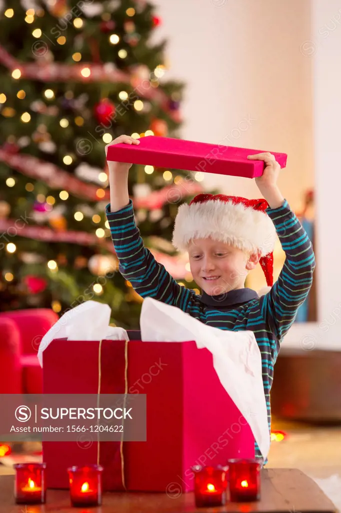 Young boy opening a Christmas present on Christmas day