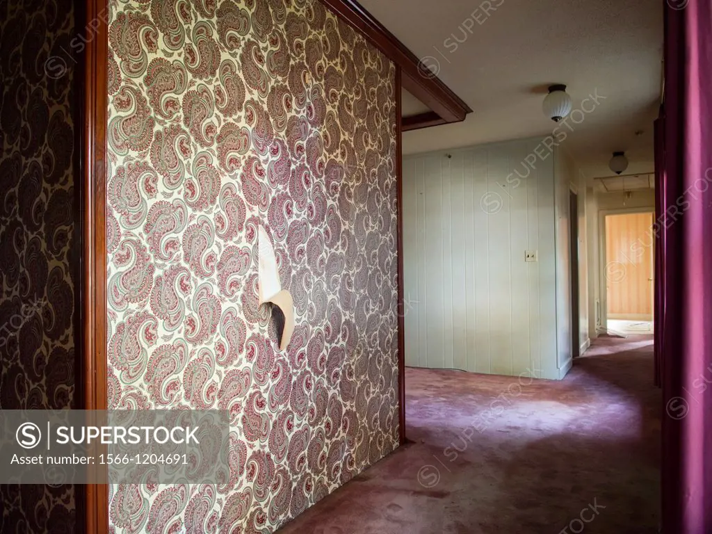 Empty room with decorated walls with wall paperinside a foreclosed home in Wilson, North Carolina, United States
