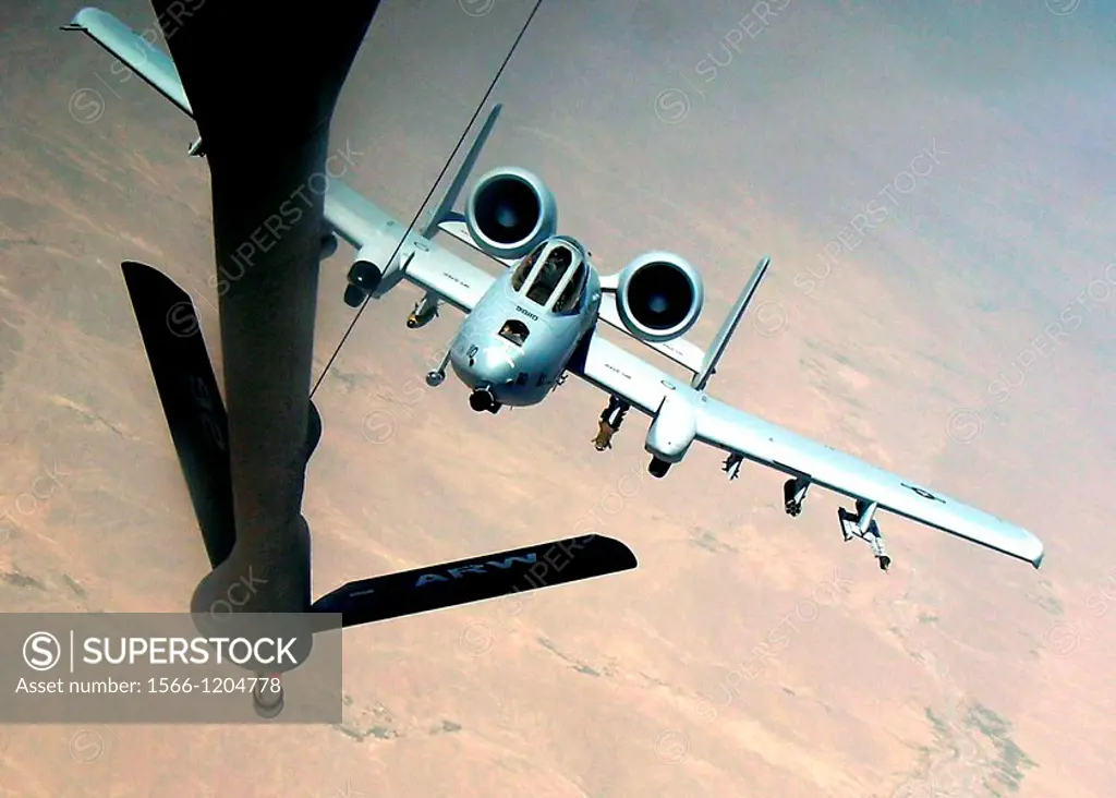 An A-10 Thunderbolt II moves into position behind a KC-135 Stratotanker on a combat mission over Afghanistan. The A-10 is deployed from the 442nd Figh...