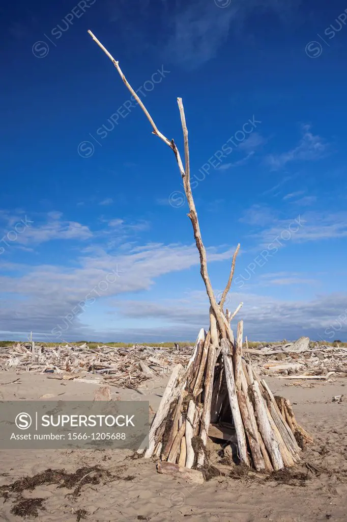 A teepee constructed of driftwood offers protection from the wind, Bandon, Oregon