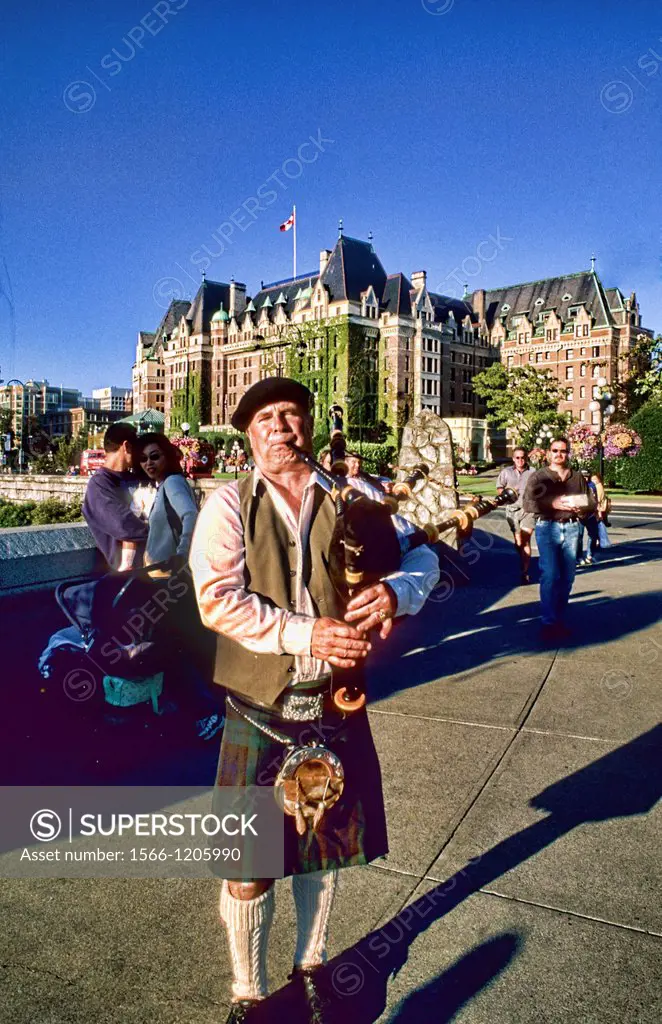 Local Scotish bag pipe player in front of the famous Empress Hotel in beautiful Victoris British Columbia Canada