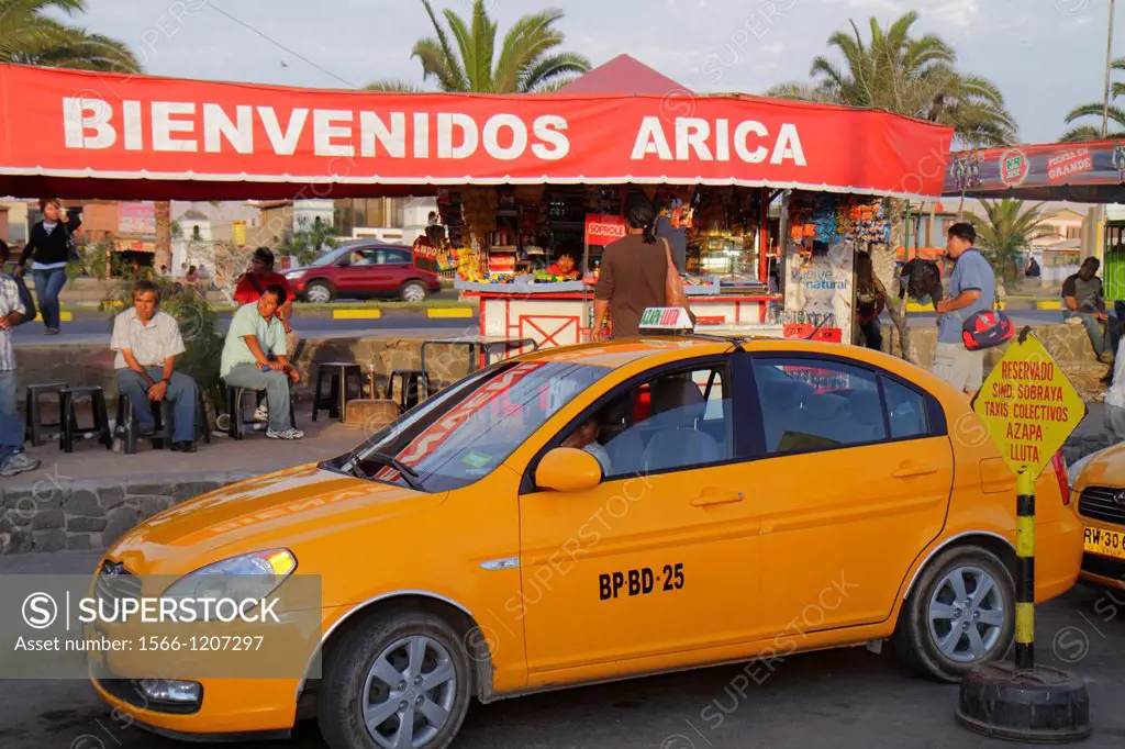 Chile, Arica, bus station, Hispanic, sign, Spanish language, welcome, taxi, cab, stand, yellow, food concession, vendor, man, waiting, sitting, ile, A...