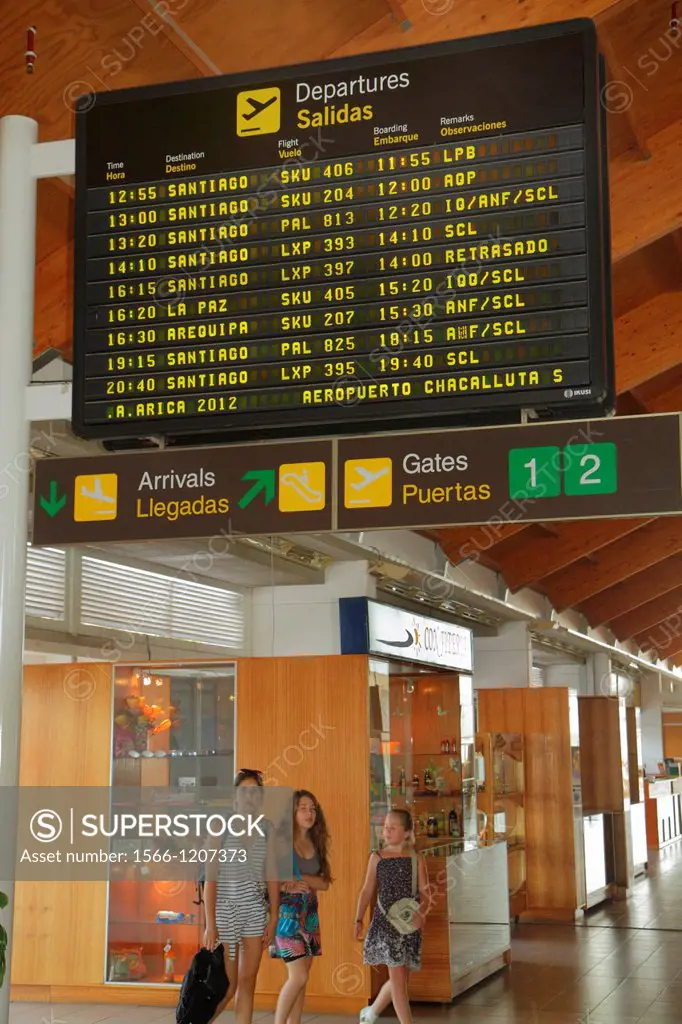 Chile, Arica, Aeropuerto de Chacalluta, airport, aviation, terminal, flight schedule, departures, bilingual, sign, gates, arrivals, Hispanic, woman, g...