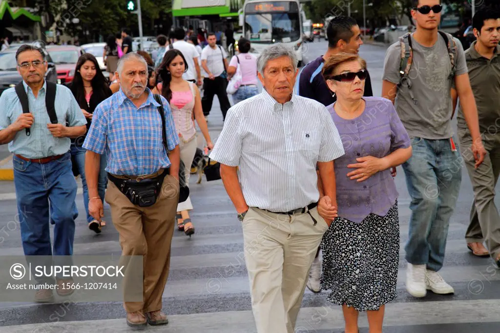 Chile, Santiago, Providencia, Avenida Vicuna Mackenna, street scene, marked crossing, crowded, Hispanic, man, woman, mature, couple, walking, pedestri...