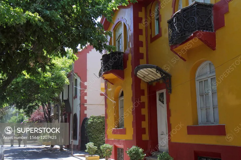 Chile, Santiago, Providencia, Calle Tomas Andrews, residential neighborhood, flats, apartments, housing, two story building, sidewalk, tree, shade, do...