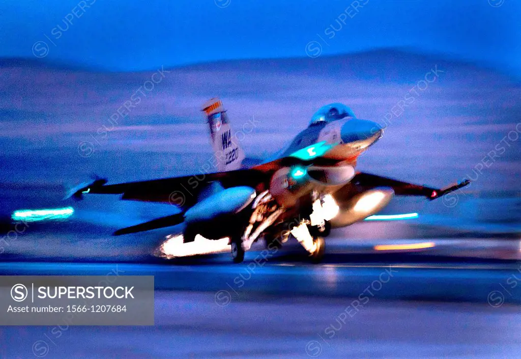 An F-16 Fighting Falcon aircraft takes off for a night mission at Nellis Air Force Base, Nev , Oct  30, 2012  The aircraft is assigned to the Weapons ...