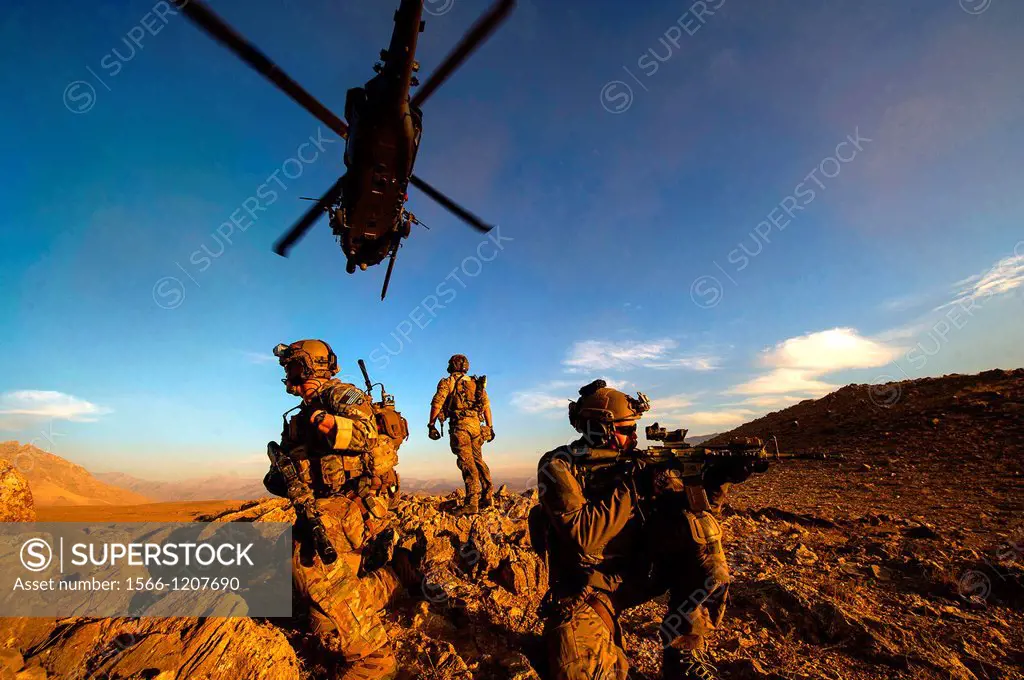Pararescuemen with the 83rd Expeditionary Rescue Squadron secure the area after being lowered from an HH-60 Pave Hawk during a mission in Afghanistan ...