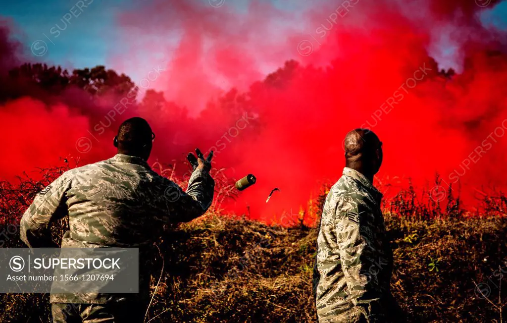 Staff Sgt  Brandon Washington, right, observes Tech  Sgt  Rudolph Stuart throw a smoke grenade during combat readiness training with the 628th Explosi...