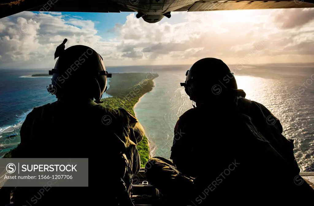 Senior Airman Timothy Oberman, left, and Staff Sgt  Nick Alarcon watch out the back of a C-130H Hercules after dropping the first pallet of humanitari...