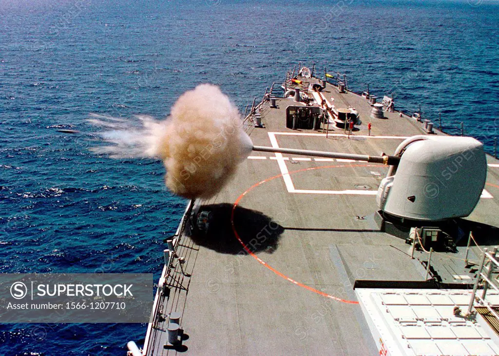 The Arleigh Burke class destroyer Benfold DDG 65 fires its five-inch 54-caliber MK45 gun during routine training operations off the coast of Southern ...