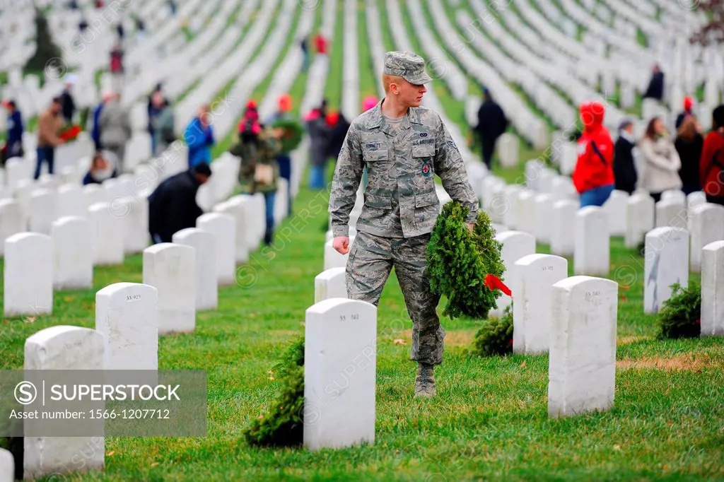 Airman 1st Class Colton Burnett carries wreaths during a Wreaths Across America event at Arlington National Cemetery, Arlington, Va , Dec  15, 2012  C...