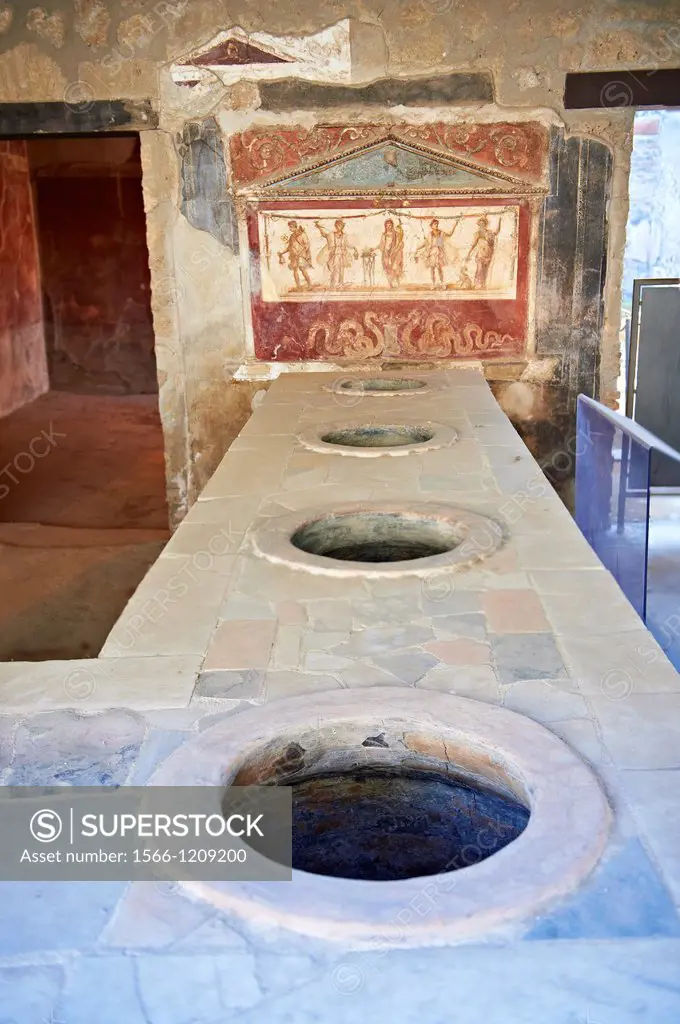 The Thermopolium of Lucius Vetutius Placidus on the Via del Abbondante, with the serving counter with holes that contained amphora of food for sale  T...
