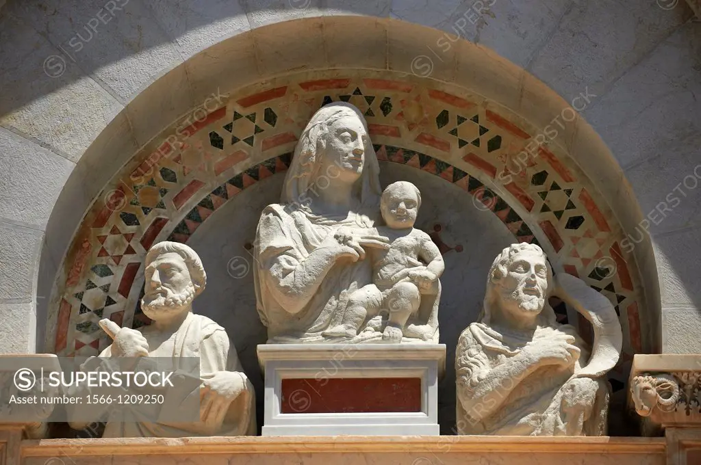 Medieval Sculptures of The Madonna & Child above the door to the The Leaning Tower Of Pisa, Italy