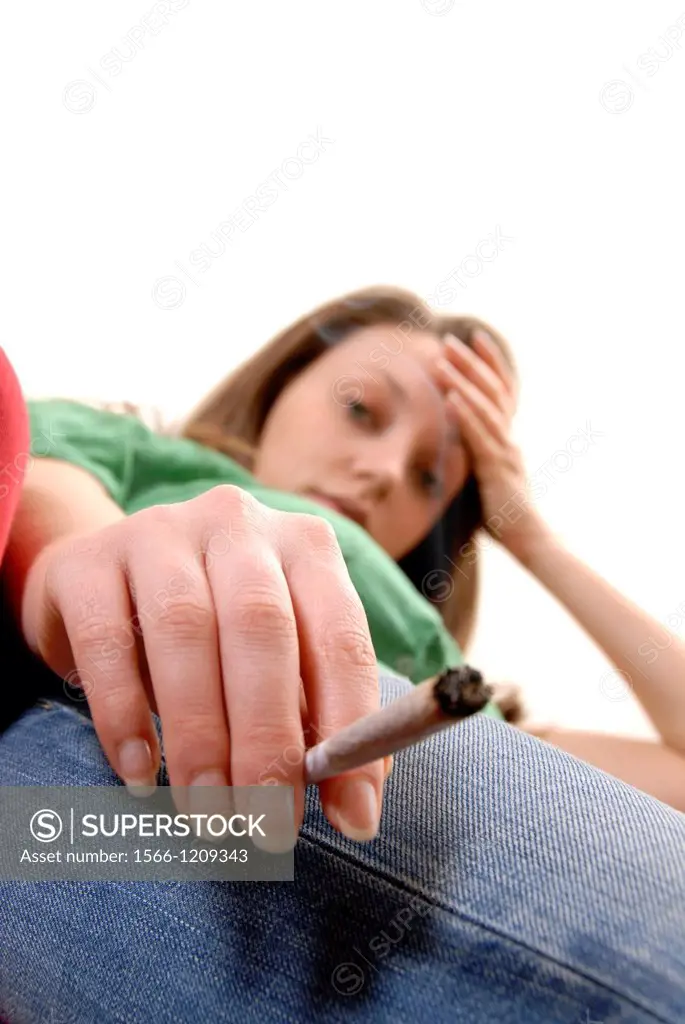 Intoxicated woman holding a cannabis cigarette