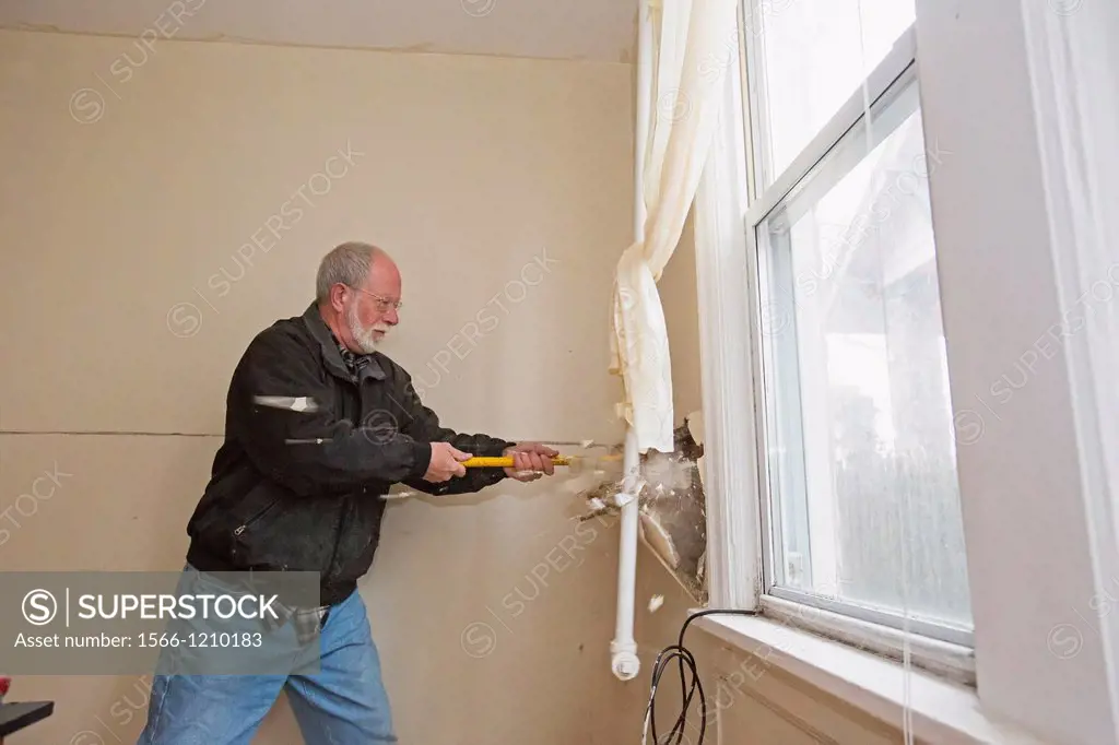 Atlantic City, New Jersey - Bill Carmen, a volunteer from New Covenant Community Church, strips drywall from the home of a low-income family that was ...