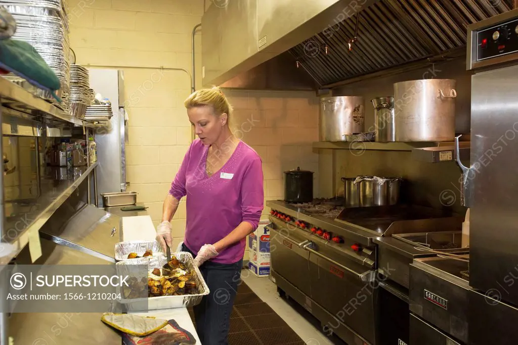 Brick, New Jersey - A volunteer with Operation Brick Food Relief prepares meals for people displaced by Hurricane Sandy