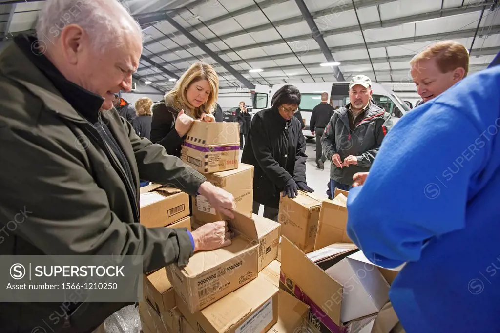 Auburn Hills, Michigan - Volunteers from Chrysler Corporation and the Michigan State Police sort toys that will be donated to children through social ...
