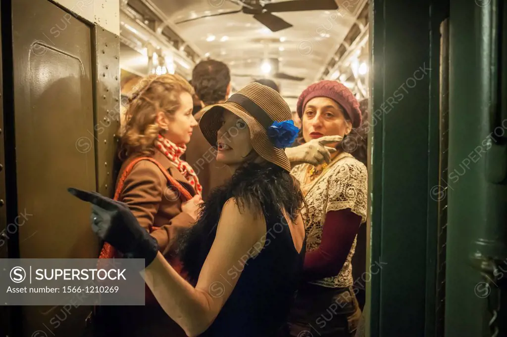 New Yorkers, tourists and subway buffs, some in period garb, travel on a vintage MTA Nostalgia Train Christmas season ride The straps, ceiling fans an...