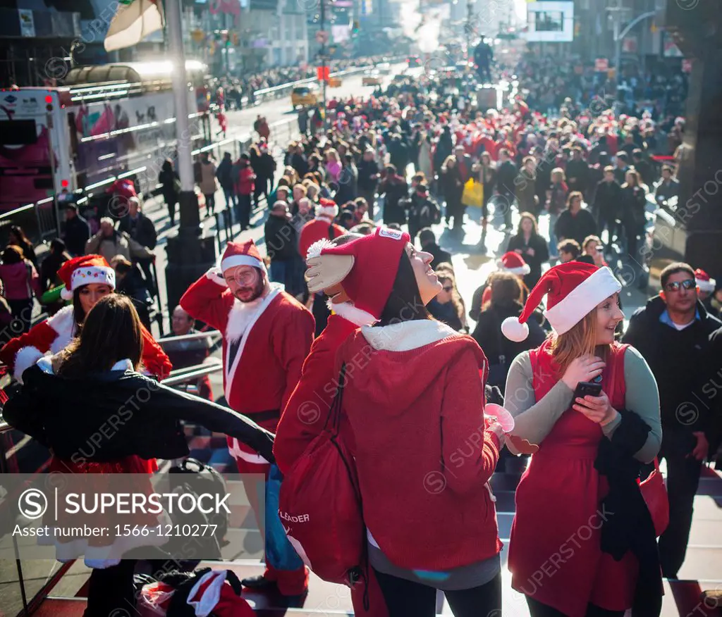 Christmas revelers participating in the annual Santacon flood midtown Manhattan in New York Santacon, primarily a pub crawl in Santa and other Christm...