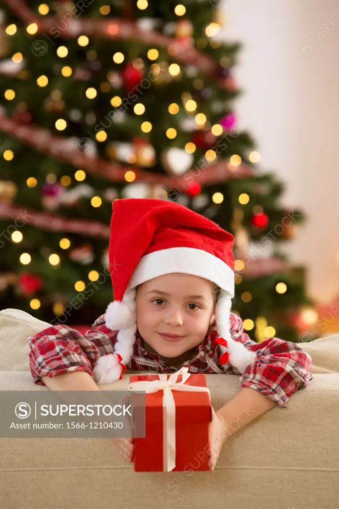 Young girl holding a gift at Christmas time